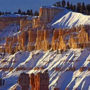 Snow covered sandstone provides the perfect backdrop for the final rays of sun to touch.